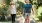 a man and a woman walking a dog on a leash