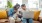 a person and a child on a couch with a laptop