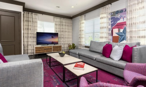 a living room with a tv and couches