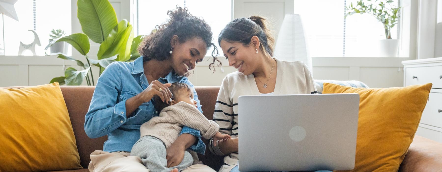 a person and a child on a couch with a laptop