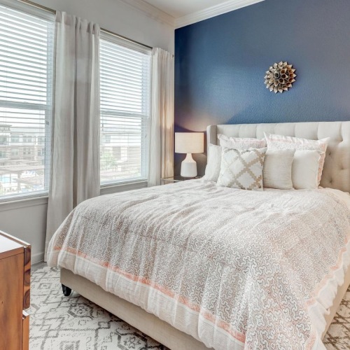 a bedroom with a bed and lamps