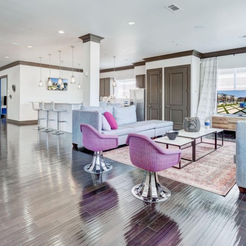 a room with a bed and chairs