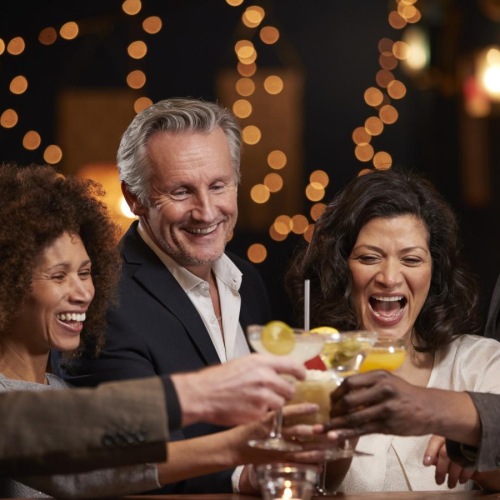 a group of people sitting at a table with drinks
